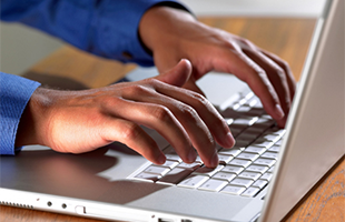Typing on Laptop - Report Delivery Software